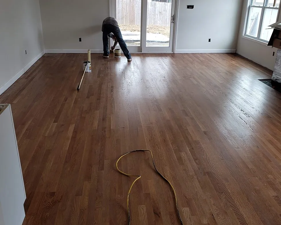 New hardwood flooring installed in a dining room with natural oak finish