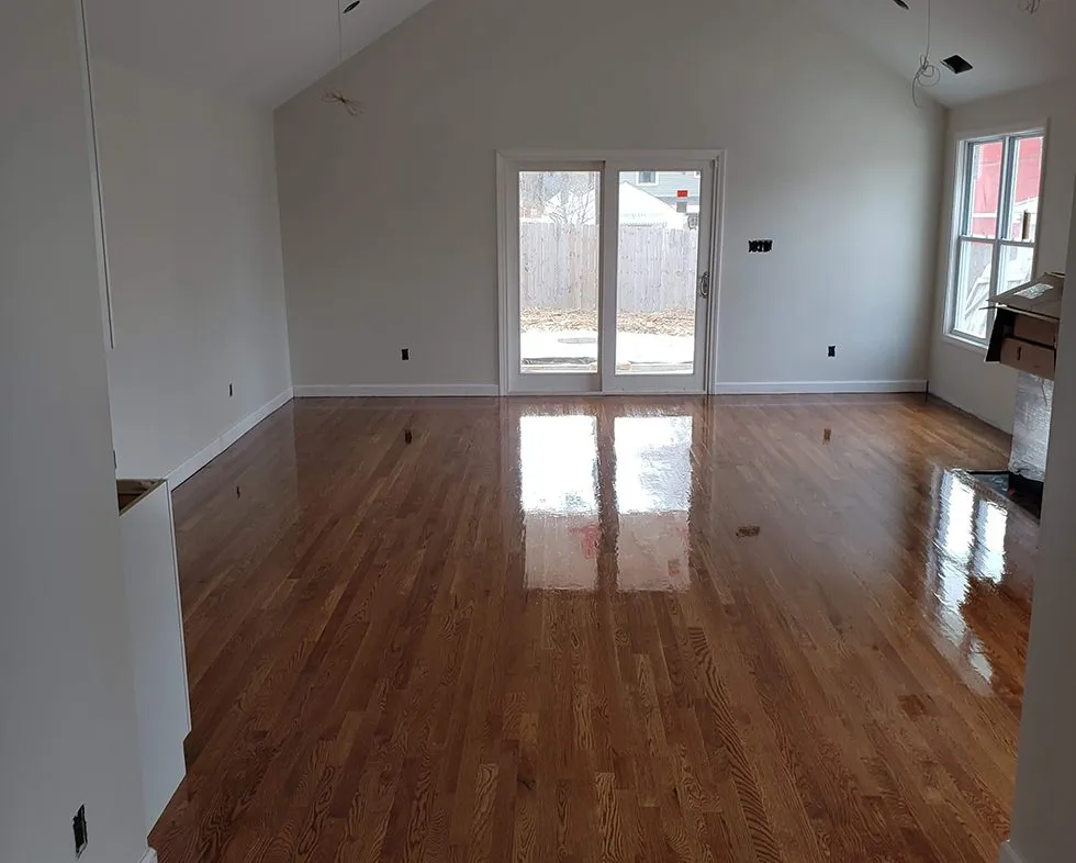 Hardwood floor installation running into a kitchen with a clean transition