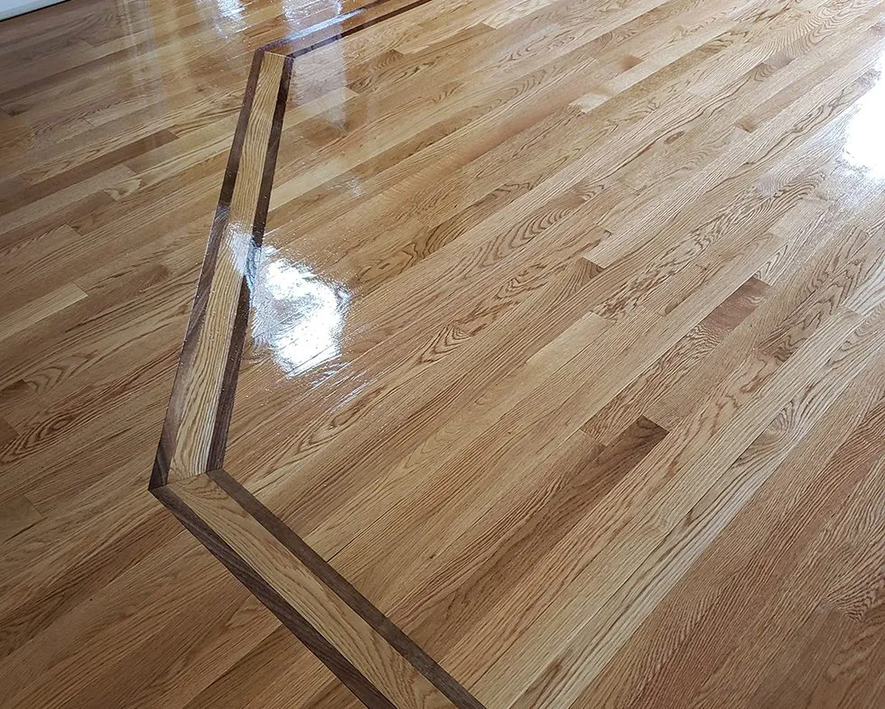 Wide plank hardwood flooring installed down a hallway
