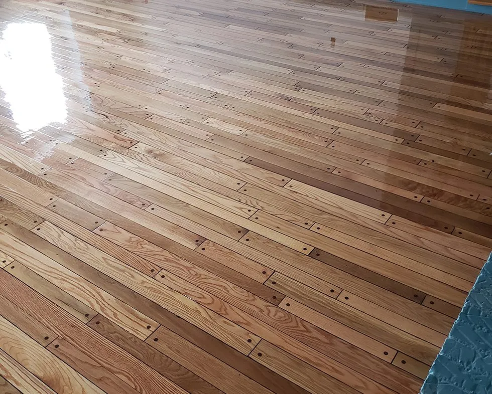 Bedroom hardwood floor refinished in a natural tone