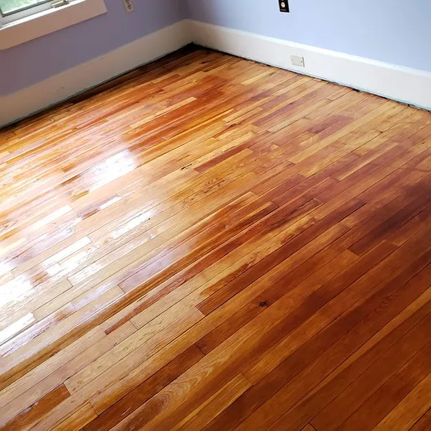Hardwood floor repair with replacement boards blended into the existing floor